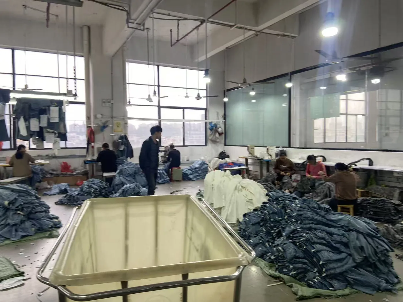A real view of the denim workshop and garment handling area.